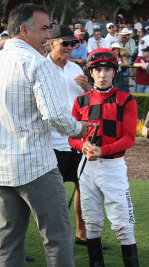 Bob Hess, Jr. talks strategy with jockey Michael Baze in the Del Mar paddock