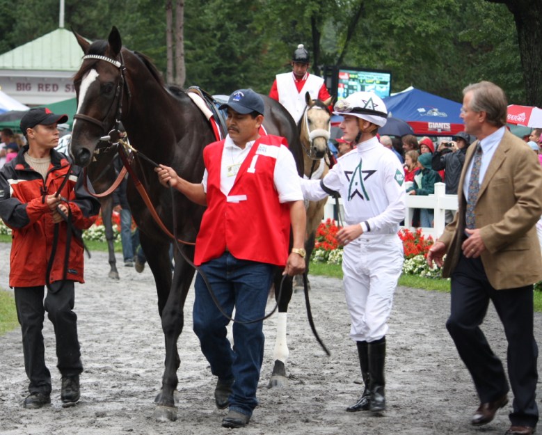 Trainer Bill Mott, far right, saddled Hold Me Back to a second-place finish in the Travers. The horse was ridden by Julien Le Paroux
