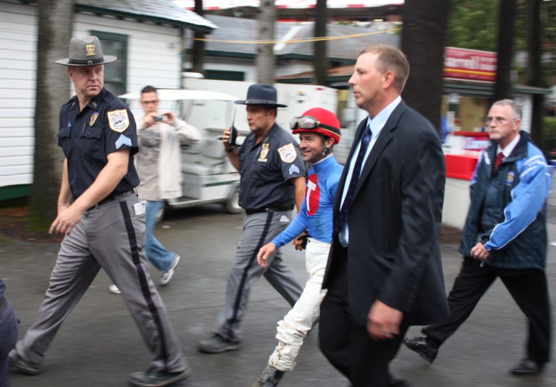 Desormeaux gets a police escort from the track through the crowd to the jockeys room