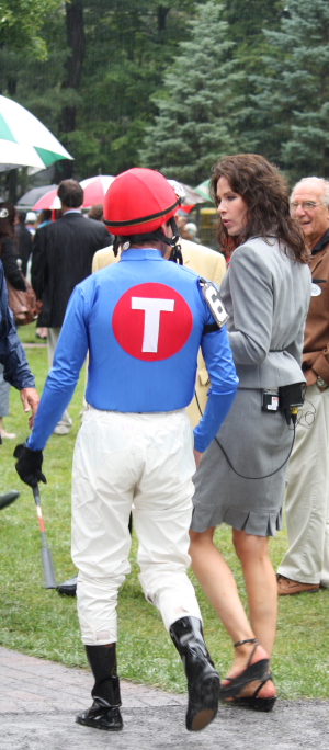 Summer Bird's jockey Kent Desormeaux is interviewed by TV's Jeannine Edwards in the paddock before the Travers.